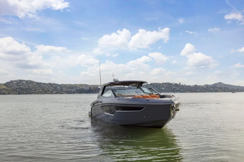 Slide: The Image of 2022 Cruisers Yachts 38 GLS South Beach IO on calm water under blue sky. - 6