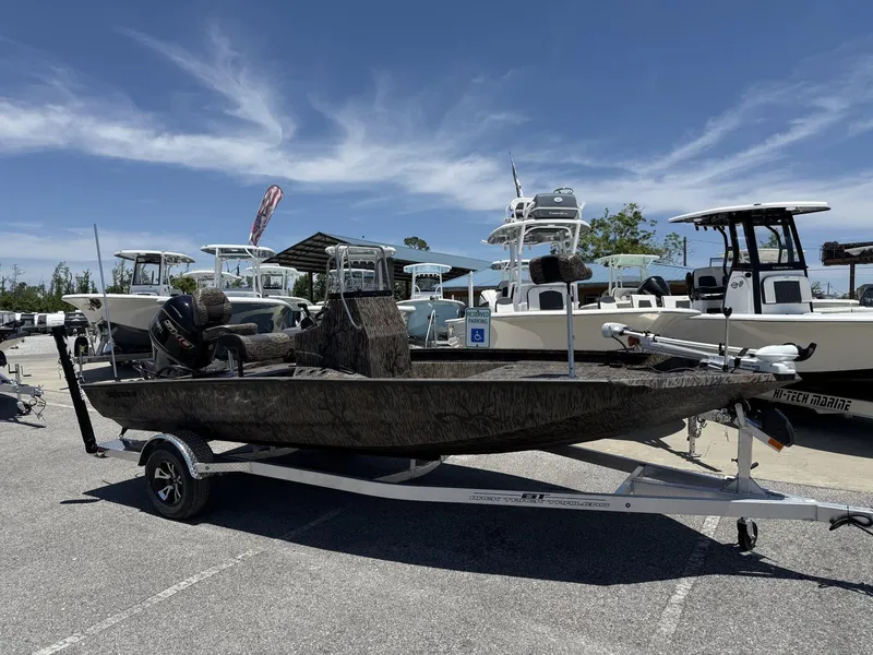 Slide: The Image of 2025 Xpress Hyper-Lift H190 Bay Series boat on trailer in marina parking lot. - 1