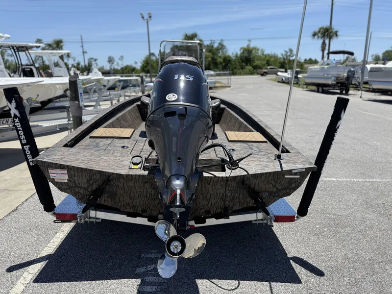 Slide: The Image of 2025 Xpress Hyper-Lift H190 Bay Series boat with 115 HP engine, parked outdoors. - 3