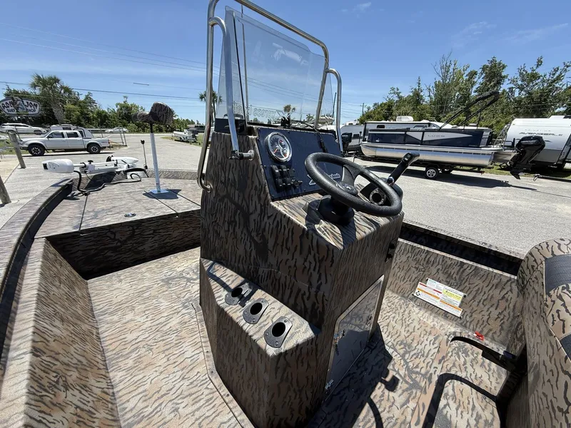 Slide: The Image of 2025 Xpress Hyper-Lift H190 Bay Series boat with camouflage interior and steering console. - 5