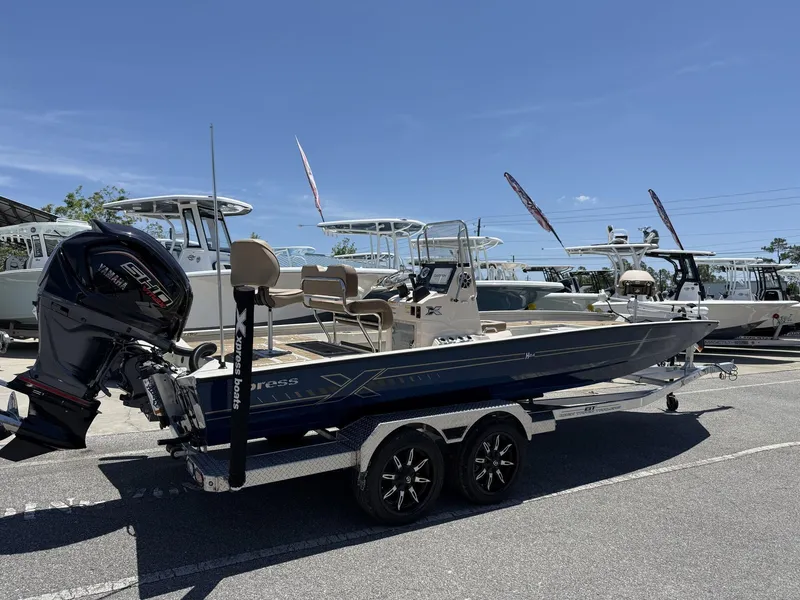 Slide: The Image of 2025 Xpress Hyper-Lift Bay Series H24 BAY boat on trailer, outdoor display. - 2