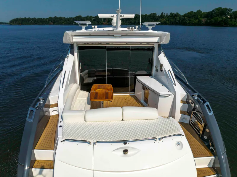 Slide: The Image of 2009 Sunseeker Predator 62 yacht with spacious deck and luxurious seating on calm water. - 10
