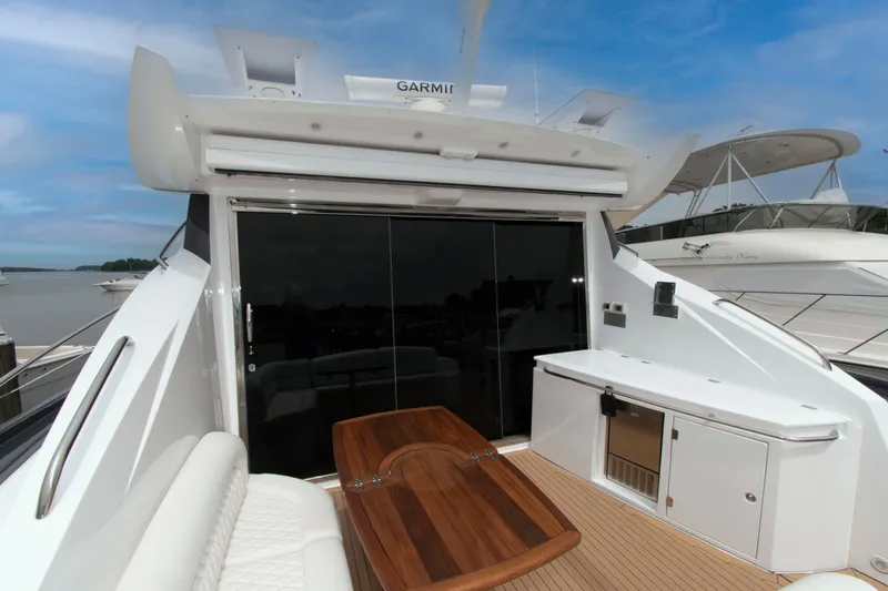 Slide: The Image of 2009 Sunseeker Predator 62 yacht deck with seating, table, and cabinetry. - 19