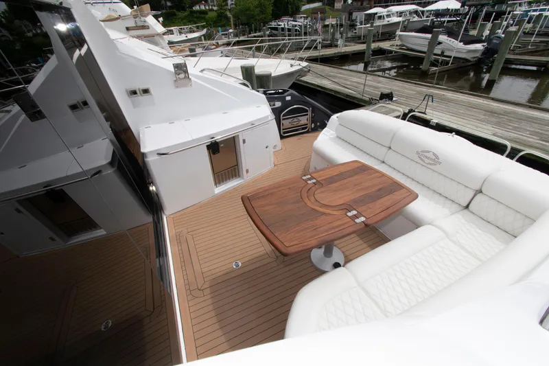 Slide: The Image of Luxurious 2009 Sunseeker Predator 62 yacht with elegant deck seating and wooden table. - 20
