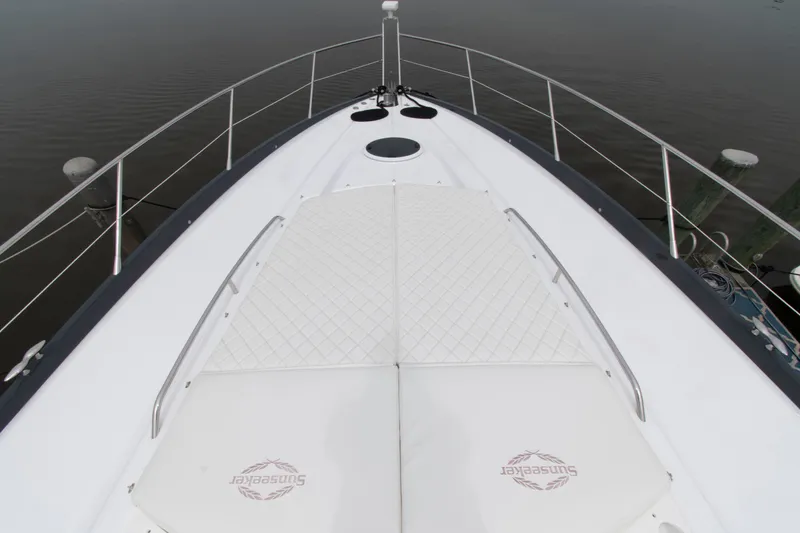 Slide: The Image of 2009 Sunseeker Predator 62 yacht bow with cushioned sunbathing area. - 26