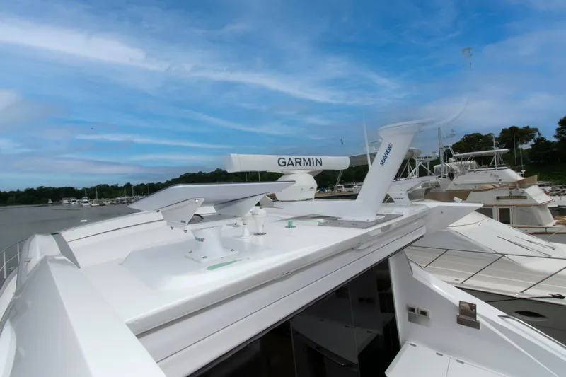 Slide: The Image of 2009 Sunseeker Predator 62 yacht with Garmin equipment, docked under a clear blue sky. - 28