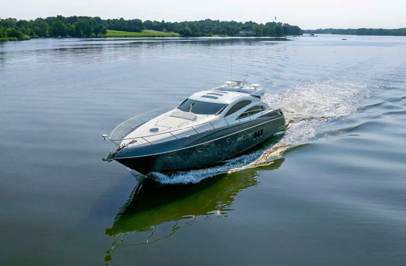 Slide: The Image of 2009 Sunseeker Predator 62 yacht cruising on a serene lake. - 3