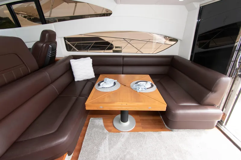Slide: The Image of Luxurious interior of 2009 Sunseeker Predator 62 yacht with brown leather seating and wooden table. - 34