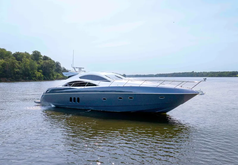 Slide: The Image of 2009 Sunseeker Predator 62 yacht cruising on a calm river with lush green shoreline. - 4