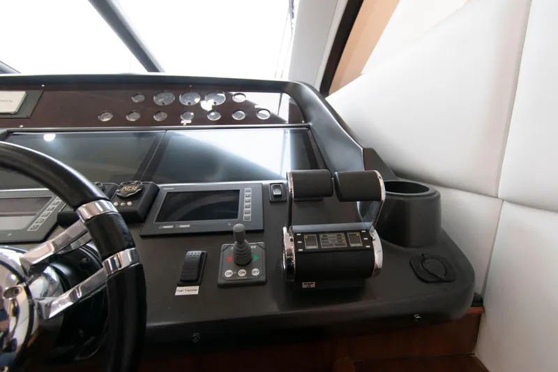 Slide: The Image of Control panel of a 2009 Sunseeker Predator 62 yacht, featuring modern navigation equipment. - 43