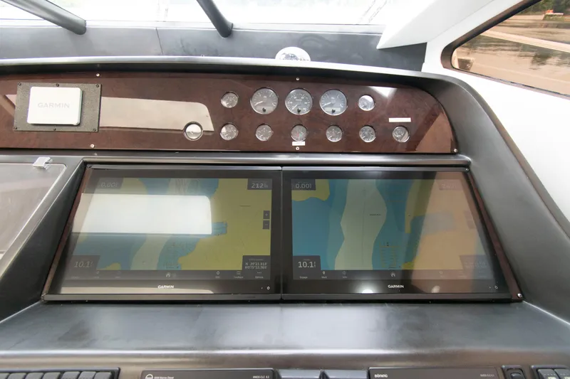 Slide: The Image of Dashboard of 2009 Sunseeker Predator 62 yacht with navigation screens and gauges. - 44