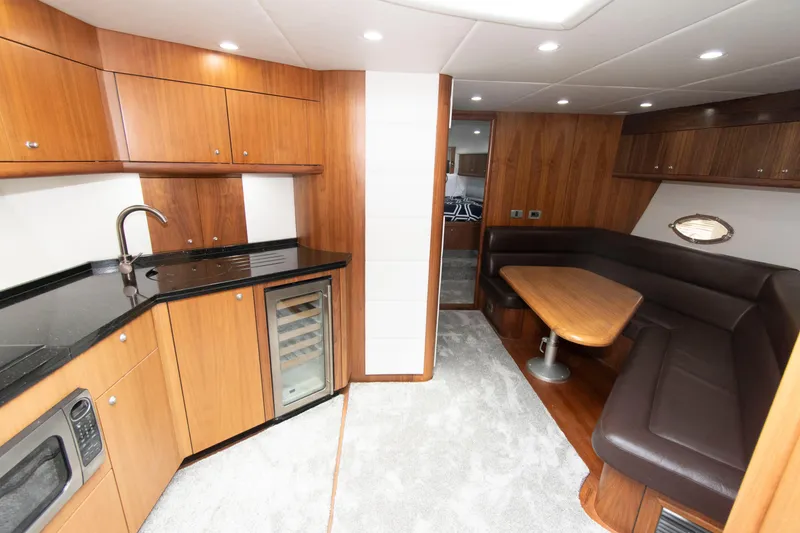 Slide: The Image of Luxurious interior of 2009 Sunseeker Predator 62 yacht with modern kitchen and dining area. - 46