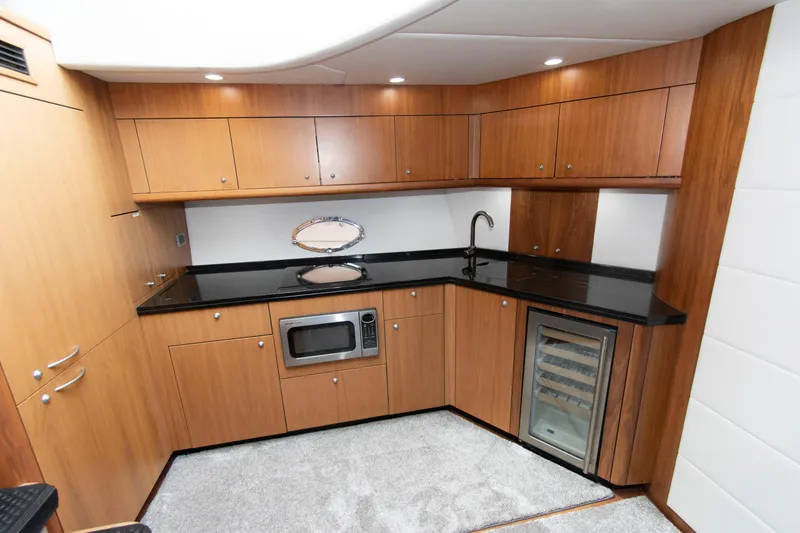 Slide: The Image of Luxurious kitchen interior of 2009 Sunseeker Predator 62 yacht with wood cabinets and modern appliances. - 47