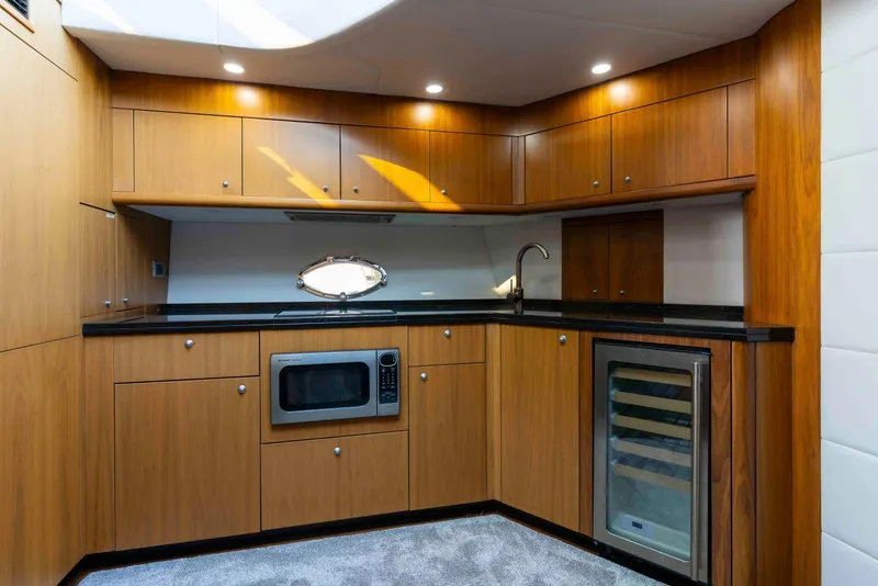 Slide: The Image of Luxurious 2009 Sunseeker Predator 62 yacht kitchen with wood cabinetry and modern appliances. - 48
