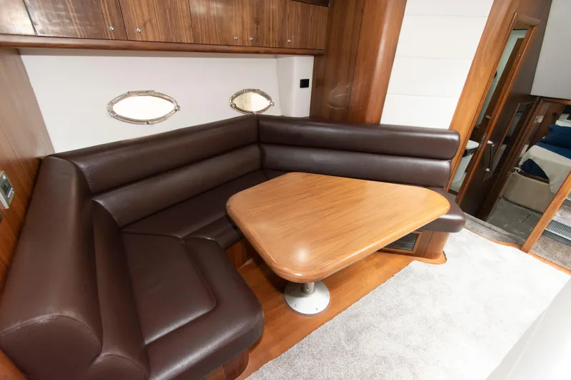 Slide: The Image of Luxurious interior of 2009 Sunseeker Predator 62 yacht with leather seating and wooden table. - 49