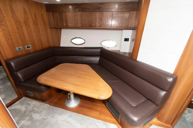 Slide: The Image of Luxurious interior of 2009 Sunseeker Predator 62 yacht with leather seating and wooden table. - 50