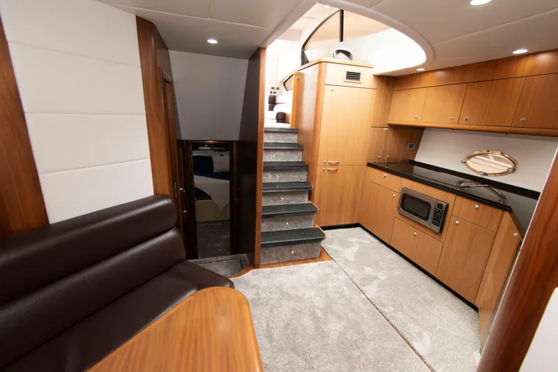 Slide: The Image of Luxurious interior of 2009 Sunseeker Predator 62 yacht with modern kitchen and seating area. - 52