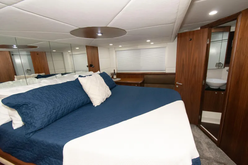 Slide: The Image of Luxurious bedroom interior of 2009 Sunseeker Predator 62 yacht with blue bedding. - 58