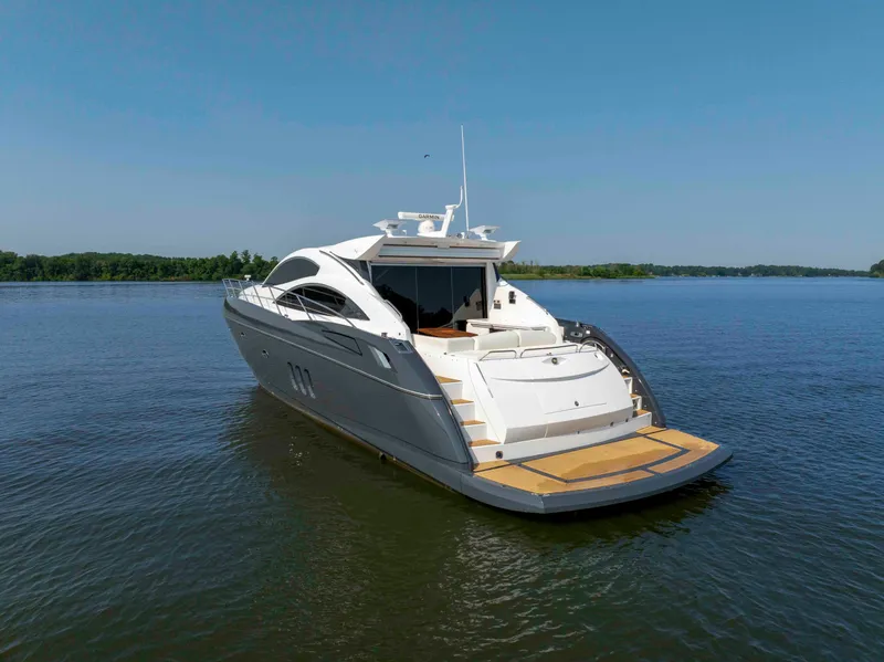 Slide: The Image of 2009 Sunseeker Predator 62 yacht on calm water, clear sky background. - 6
