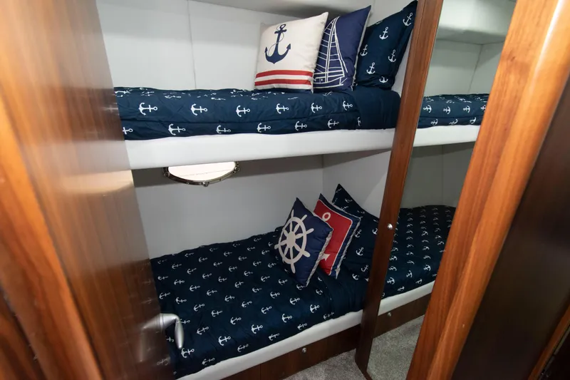 Slide: The Image of Bunk beds with nautical-themed bedding in 2009 Sunseeker Predator 62 yacht cabin. - 65