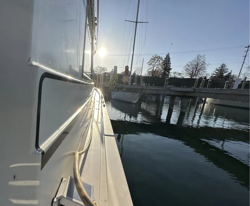 Slide: The Image of 2004 Camano Troll boat docked at marina during sunset, reflecting on calm water. - 19