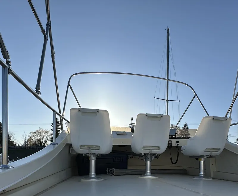 Slide: The Image of 2004 Camano Troll boat with three seats, silhouetted against a clear sky. - 20