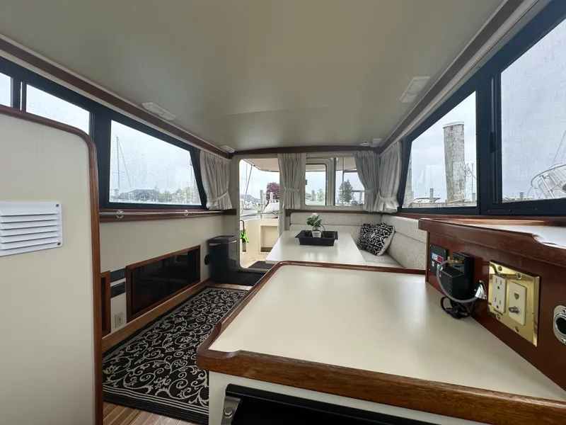 Slide: The Image of Interior of a 2004 Camano Troll boat with seating and windows. - 34