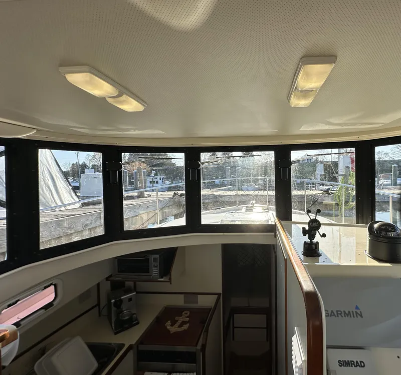Slide: The Image of Interior view of 2004 Camano Troll boat with windows and navigation equipment. - 35