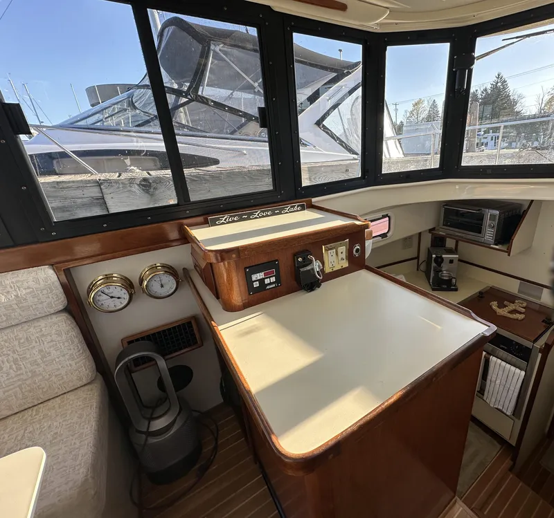 Slide: The Image of 2004 Camano Troll boat interior with control panel, gauges, and windows. - 36