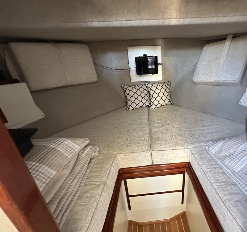 Slide: The Image of Cozy cabin interior of a 2004 Camano Troll boat with cushioned bedding. - 39