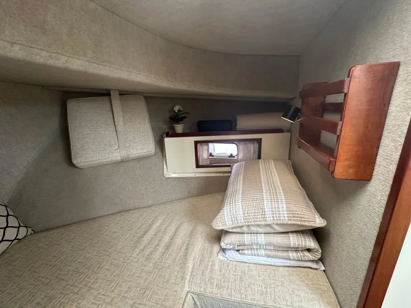 Slide: The Image of Cozy interior cabin of a 2004 Camano Troll boat with cushions and wooden accents. - 42