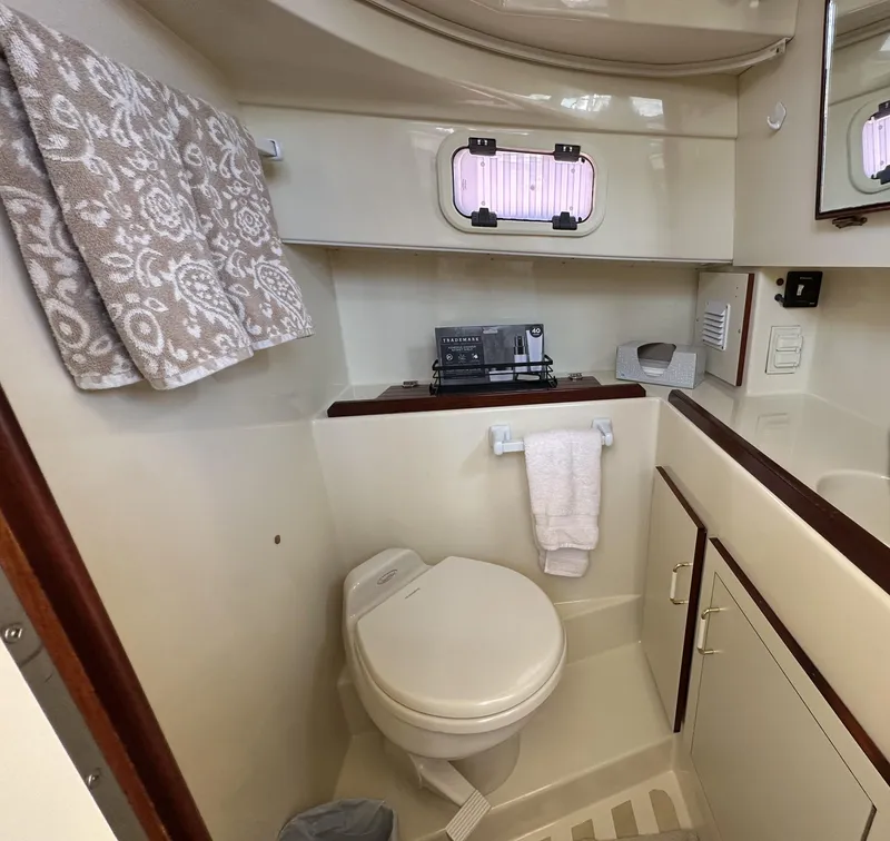 Slide: The Image of Compact bathroom in a 2004 Camano Troll boat, featuring a toilet and sink. - 46