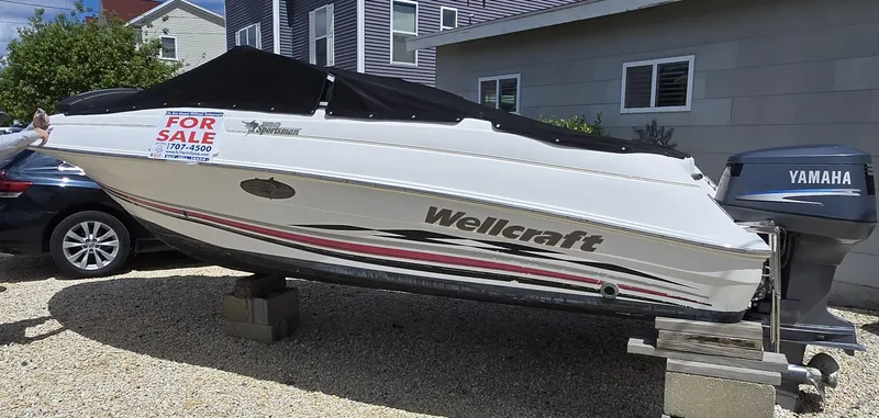 The Image of 2002 Wellcraft 180 Sportsman boat for sale, parked on blocks, with Yamaha outboard motor. - 0