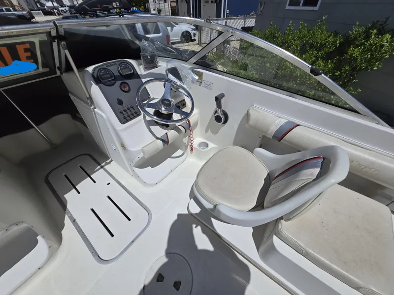 Slide: The Image of 2002 Wellcraft 180 Sportsman boat interior with steering wheel and seating. - 11