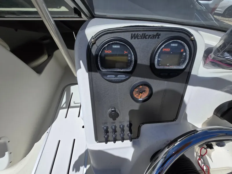 Slide: The Image of Dashboard of a 2002 Wellcraft 180 Sportsman boat with gauges and controls. - 17