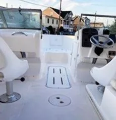 Slide: The Image of 2002 Wellcraft 180 Sportsman boat interior with white seating and steering wheel. - 2