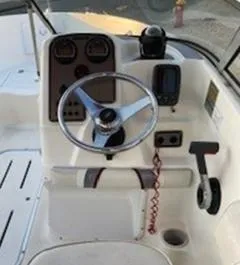 Slide: The Image of 2002 Wellcraft 180 Sportsman boat dashboard with steering wheel and controls. - 22