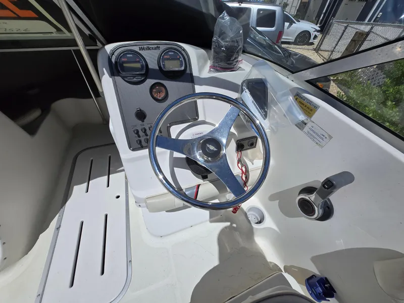 Slide: The Image of 2002 Wellcraft 180 Sportsman boat cockpit with steering wheel and control panel. - 5