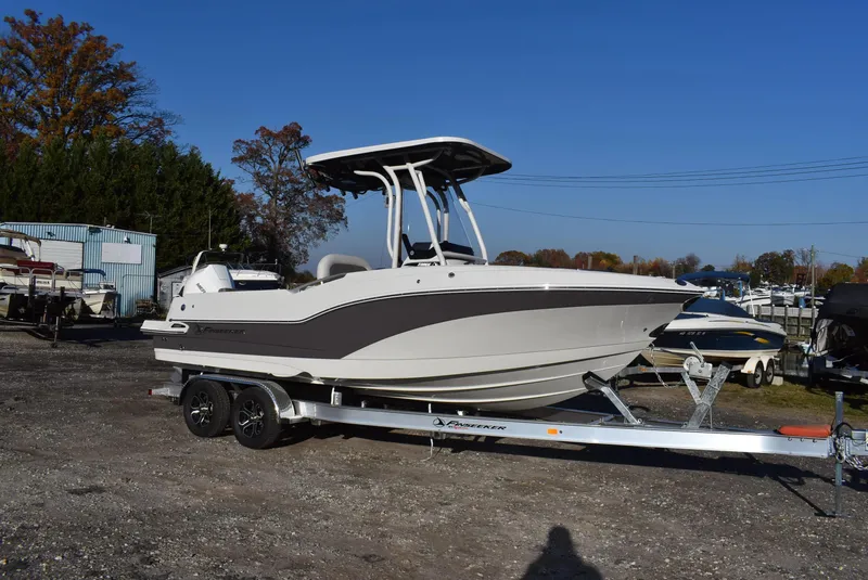 Slide: The Image of 2024 Finseeker 230 CC boat on trailer, parked outdoors under clear blue sky. - 2