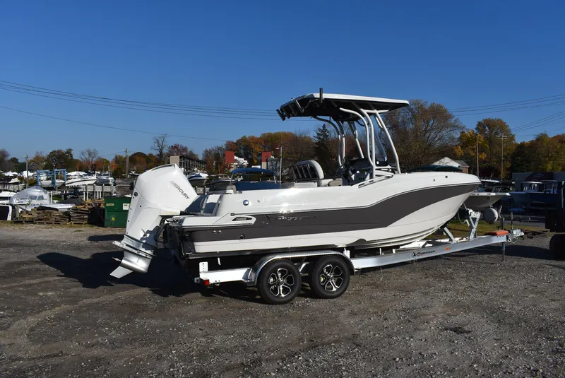 Slide: The Image of 2024 Finseeker 230 CC boat on trailer, parked outdoors under clear blue sky. - 3
