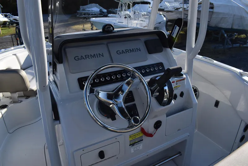 Slide: The Image of 2024 Finseeker 230 CC boat dashboard with dual Garmin displays and steering wheel. - 7