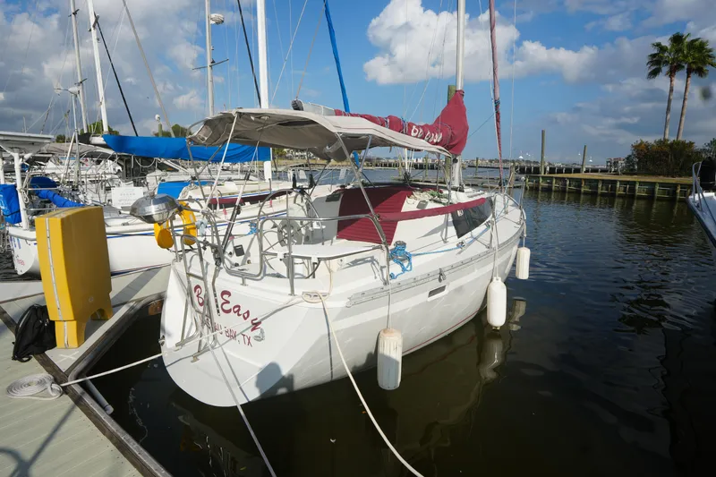 The Image of 1987 O'Day 322 sailboat docked at marina under blue sky. - 0