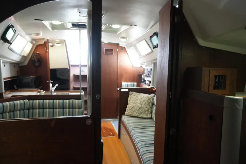 Slide: The Image of Interior of 1987 O'Day 322 sailboat with cozy seating and wooden finishes. - 12
