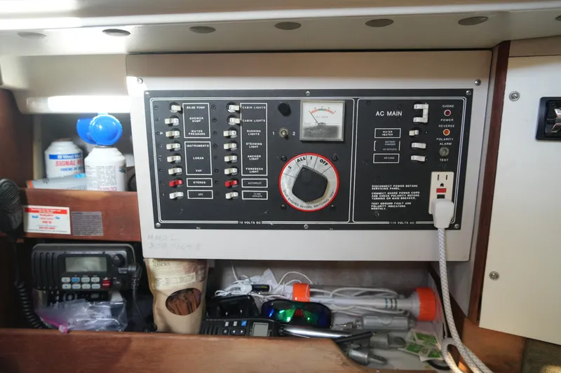 Slide: The Image of Electrical control panel inside 1987 O'Day 322 sailboat, featuring switches and outlets. - 16