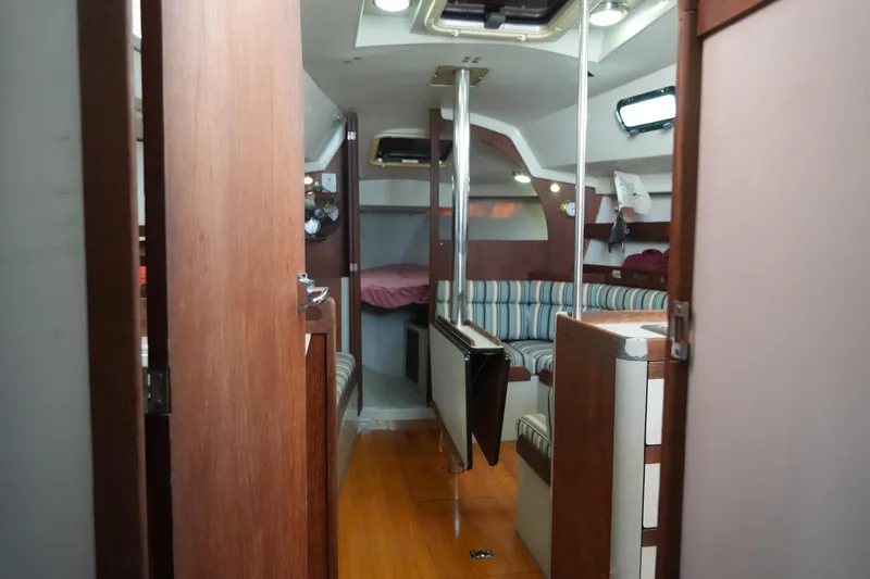 Slide: The Image of Interior of 1987 O'Day 322 sailboat with wood finish and striped seating. - 19