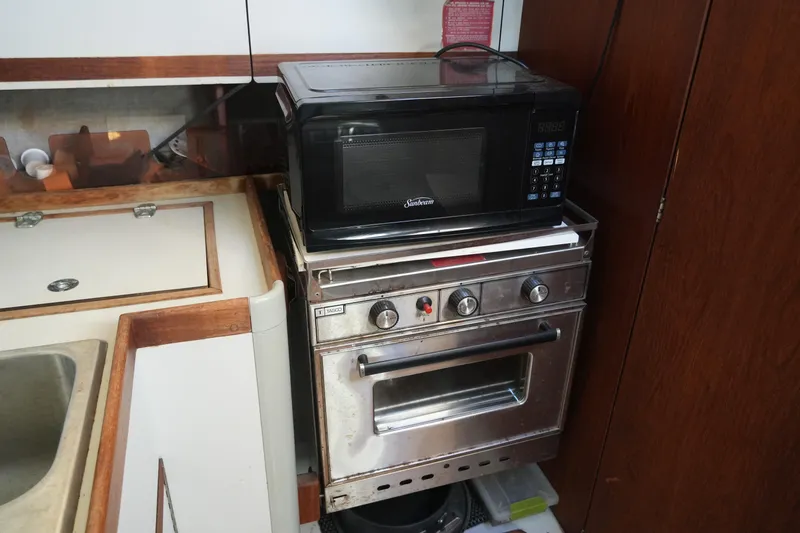 Slide: The Image of Compact kitchen area in 1987 O'Day 322 sailboat with microwave and stove. - 22