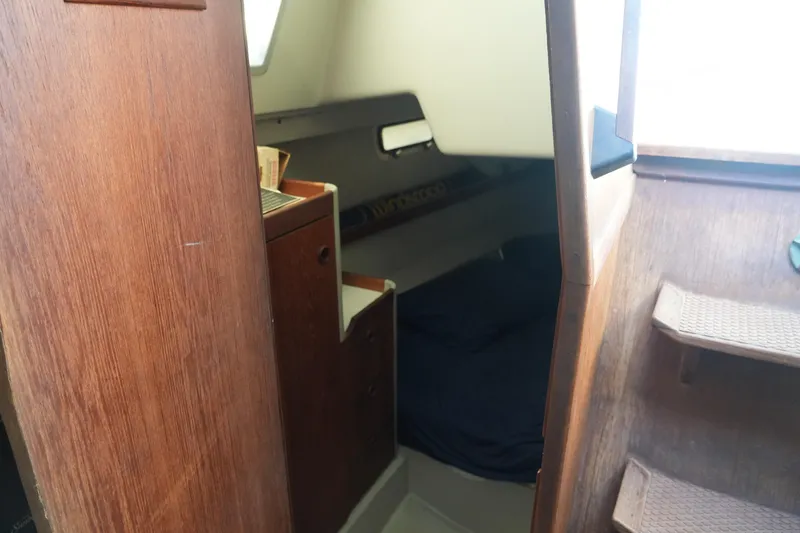 Slide: The Image of Interior cabin of 1987 O'Day 322 sailboat with wooden finishes and compact sleeping area. - 23