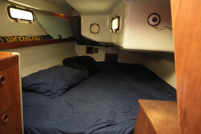 Slide: The Image of Cozy cabin interior of 1987 O'Day 322 sailboat with blue bedding and wooden accents. - 24