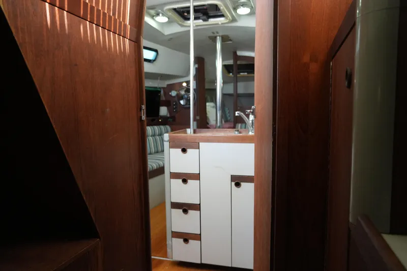 Slide: The Image of Interior of 1987 O'Day 322 sailboat with wooden cabinetry and striped seating. - 25