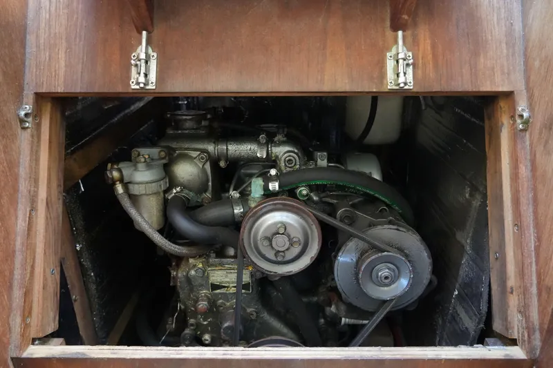 Slide: The Image of 1987 O'Day 322 engine compartment with visible mechanical components and wooden enclosure. - 26